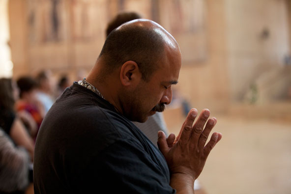 A man prays as Archbishop Jose H. Gomez of Los Angeles celebrates a Mass for religious freedom at the Cathedral of Our Lady of the Angeles in observance of the "fortnight for freedom," which began June 21 and ends July 4. The two-week period will emphasi ze church teaching on religious freedom in light of the federal contraceptive mandate.(CNS photo/Victor Aleman, Vida Nueva)