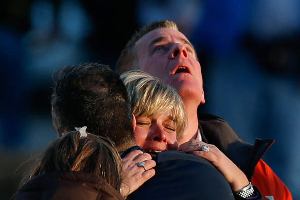 FAMILY MEMBERS GRIEVE NEAR SITE OF CONNECTICUT SCHOOL TRAGEDYFamily members of victims grieve near Sandy Hook Elementary School, where a gunman opened fire on school children and staff in Newtown, Conn., Dec. 14. Twenty children and seven adults were killed in the shooting at the school. (CNS photo/Adrees Latif)