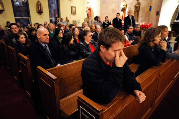 Mourners gather inside St. Rose of Lima Church for a vigil service in Newtown, Conn., Dec. 14. At least eight child victims of the Sandy Hook Elementary School shooting massacre will be buried from St. Rose, located a little more than a mile from the sch ool. (CNS photo/Andrew Gombert, pool via Reuters)