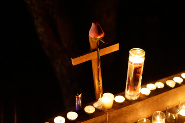 A rose is tied to a cross on a memorial set outside St. Rose of Lima Church in Newtown, Conn., Dec. 14. At least eight child victims of the Sandy Hook Elementary School shooting massacre will be buried from St. Rose, located a little more than a mile fr om the school. (CNS photo/Joshua Lott, Reuters)