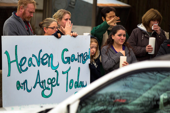 Mourners watch as the hearse containing the body of Sandy Hook Elementary School student James Mattioli drives past on the way to St. John's Catholic Cemetery in Darien, Conn., Dec. 18. The 6-year-old first grader was among the 20 schoolchildren killed D ec. 14 in one of the worst mass shootings in U.S. history. His funeral Mass was celebrated at St. Rose of Lima Church in Newton. (CNS photo/Lucas Jackson, Reuters)