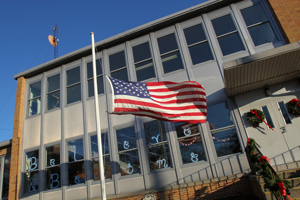 A U.S. flag flies at half-staff at St. Martin of Tours School in Amityville, N.Y., Dec. 19, in memory of the 26 students and staff members killed at Sandy Hook Elementary School in Newtown, Conn. (CNS photo/Gregory A. Shemitz) 