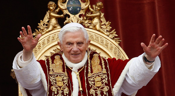 Pope Benedict XVI greets the crowd after delivering his Christmas message "urbi et orbi" (to the city and the world) from the central balcony of St. Peter's Basilica at the Vatican Dec. 25. (CNS photo/Paul Haring)