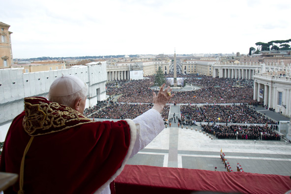 Pope Benedict XVI waves as he blesses the crowd during his Christmas message "urbi et orbi" (to the city of Rome and the world) from the central balcony of St. Peter's Basilica at the Vatican Dec. 25. (CNS photo/L'Osservatore Romano via Reuters)