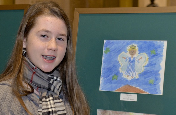 Ally Fallon of the Diocese of Bridgeport, Conn., winner of the Christmas Artwork Contest of the Missionary Childhood Association, poses with her winning artwork of a Christmas angel at the Basilica of the National Shrine of the Immaculate Conception in Washington Dec. 7. All the contest artwork will be on display at the shrine through Epiphany. (CNS photo/Eddie Arrossi, courtesy Pontifical Mission Societies)
