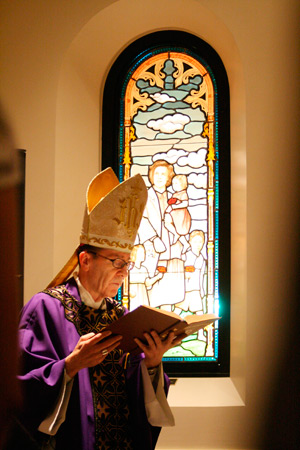 Bishop Thomas J. Olmsted blesses a stained glass window depicting St. Gianna Berretta Molla at the Diocesan Pastoral Center’s Virginia G. Piper Chapel, which is dedicated to Blessed John Paul II. Local Catholic Armando Ruiz donated the window in honor of his late wife, Peggy, who died in April. (Ambria Hammel/CATHOLIC SUN)