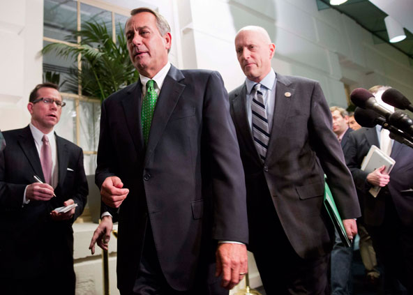 Speaker of the House John Boehner walks with Rep. Dave Camp, R-Mich., after a meeting with House Republicans about a "fiscal cliff" deal on Capitol Hill in Washington Jan. 1. Lawmakers approved a deal preventing huge tax hikes and spending cuts that thre atened the stability of the worldâ€™s largest economy. (CNS photo/Joshua Roberts, Reuters)