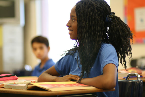 Senniah Mason, a seventh-grader at St. Louis the King, listens during religon class the first week of school. The annual Charity and Development Appeal supports Catholic education at schools throughout the Diocese of Phoenix. (J.D. Long-Garcia/CATHOLIC SUN)