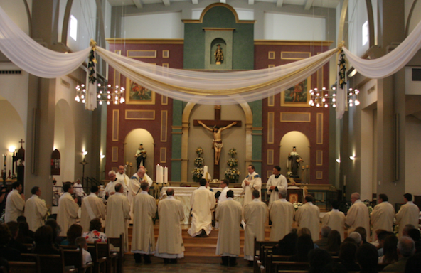 Newly ordained deacons receive the book of the Gospels during their ordination at St. Thomas Aquinas in November 2012 (SUN FILE PHOTO)