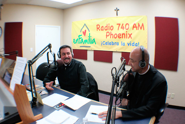 Fr. Carlos Gomez speaks with Fr. Ernesto Reynoso Jan. 16 during the second broadcast of "Catholic Essence," a new, locally-produced Catholic radio show on 740 AM, Radio en Familia. (J.D. Long-García/CATHOLIC SUN)