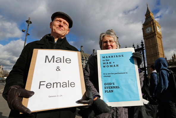 Christian activists Jonathan Longstaff and Jenny Rose, both from London, protest outside Parliament before a vote on same-sex marriage in London Feb. 5. British Prime Minister David Cameron is expected to see his ruling Conservative party split in two on Tuesday over his government's plans to legalize same-sex marriage. (CNS photo/Chris Helgren, Reuters)