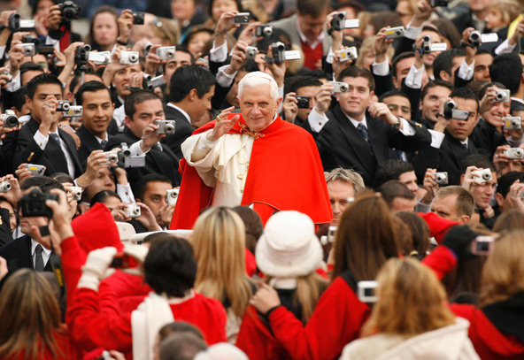 Pilgrims have their cameras ready as Pope Benedict XVI makes his way through the crowd in St. Peter's Square at the Vatican before a general audience in 2007. The 85-year-old pontiff said he no longer has the energy to exercise his ministry over the univ ersal church and will resign at the end of the month. (CNS photo/Paul Haring) 