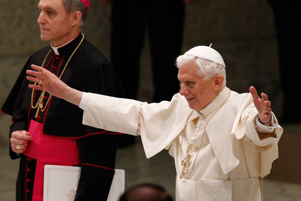 Pope Benedict XVI greets the crowd as he begins his general audience in Paul VI hall at the Vatican Feb. 13. The pope surprised the world Feb. 11 by announcing that he no longer has strength to exercise his ministry and will retire at the end of the mont h. (CNS photo/Paul Haring) 