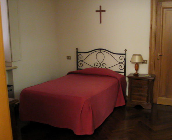 An unadorned bedroom at the Domus Sancta Marthae, the residence where cardinal electors will rest during the conclave, is seen in a 2004 file photo. A bus will transport most of the sequestered cardinals to and from the Sistine Chapel, although some may choose to walk. (CNS photo)
