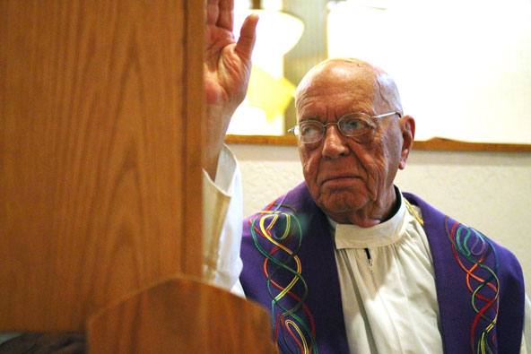 Fr. Anthony Sigman, a retired priest who serves St. Mary Parish in Chandler, demonstrates the granting of absolution that occurs during the sacrament of reconciliation. The priest, acting in the person of Christ, can absolve a person of sins. (J.D. Long-García/CATHOLIC SUN)