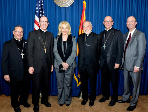 Gov. Brewer’s plan to expand Medicaid coverage for the poor was celebrated by the bishops of the Arizona Catholic Conference. From left: Auxiliary Bishop Eduardo A. Nevares and Bishop Thomas J. Olmsted of Phoenix, Gov. Jan Brewer, Bishop Gerald F. Kicanas of Tucson, Bishop James S. Wall of Gallup and Ron Johnson executive director of the Arizona Catholic Conference. 