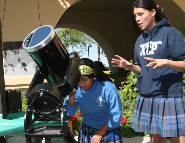 A Xavier student explains astronomical concepts to a St. Louis the King student during the first "Girls Have IT Day" in 2009. The idea is to show young women that they can be scientists and engineers and still make a vital difference in the world. (Ambria Hammel/CATHOLIC SUN)