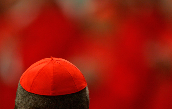 A red skull cap is seen as the world's cardinals gather in St. Peter's Basilica before the start of the last conclave in this 2005 file photo. Pope Benedict XVI named 24 new cardinals Oct. 20. The upcoming consistory will leave the College of Cardinals w ith 203 members, a new record. Of those, 121 will be under age 80 and eligible to vote in a papal election. (CNS photo by Nancy Wiechec) 