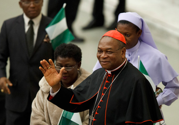 New Cardinal John Olorunfemi Onaiyekan of Abuja, Nigeria, waves as he greets guests before Pope Benedict XVI's audience in Paul VI hall at the Vatican Nov. 26. The pope created six new cardinals from four different continents at a Nov. 24 consistory. (CN S photo/Paul Haring)