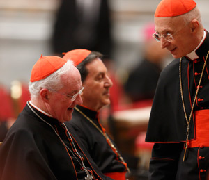 Canadian Cardinal Marc Ouellet, prefect of the Congregation for Bishops, left, and Italian Cardinal Angelo Bagnasco of Genoa, right, are seen before a prayer service with eucharistic adoration in St. Peter's Basilica at the Vatican March 6. Also pictured is Cardinal Ruben Salazar Gomez of Bogota, Colombia, center. (CNS photo/Paul Haring)