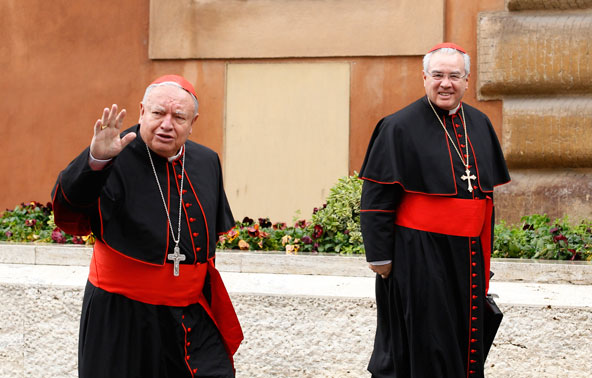 Cardinals Juan Sandoval Iniguez, retired archbishop of Guadalajara, Mexico, and Francisco Robles Ortega of Guadalajara, arrive for the fourth day of general congregation meetings in the synod hall at the Vatican March 7. (CNS photo/Paul Haring) 