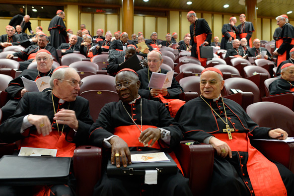Italian Cardinal Giovanni Battista Re, Nigerian Cardinal Francis Arinze and Portuguese Cardinal Josz Saraiva Martins are seated in synod hall at the Vatican March 7 for one of several general congregation meetings being held ahead of the conclave. (CNS photo/L'Osservatore Romano)