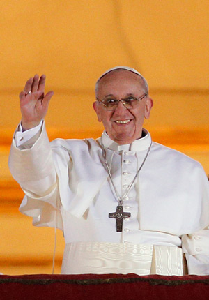 Pope Francis appears for the first time on the central balcony of St. Peter's Basilica at the Vatican March 13. Cardinal Jorge Mario Bergoglio of Argentina was elected the 266th Roman Catholic pontiff. He is the first Jesuit and first Latin American po pe. (CNS photo/Paul Haring)