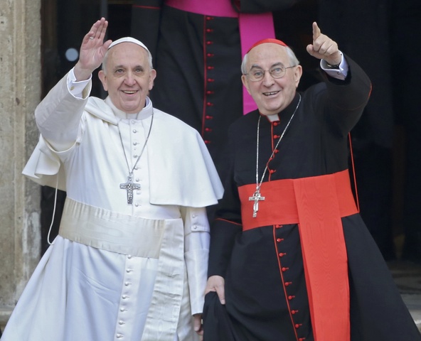 Newly-elected Pope Francis, Cardinal Jorge Mario Bergoglio of Argentina, waves after praying at the Basilica of St. Mary Major in Rome March 14. At right is Cardinal Agostino Vallini, papal vicar for Rome. (CNS photo/Alessandro Bianchi, Reuters)