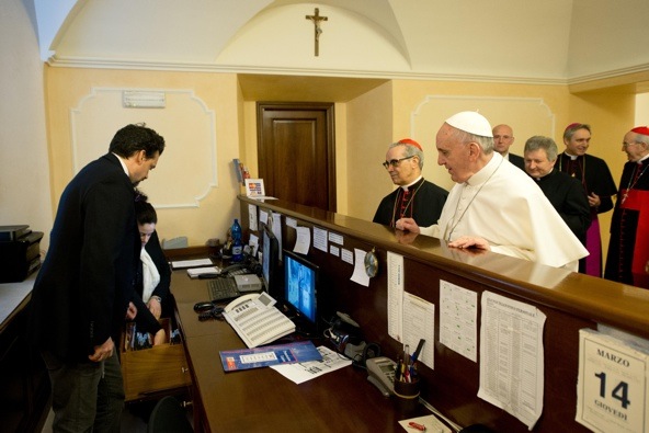 Newly elected Pope Francis checks out of the church-run residence March 14 where he had stayed in Rome. The pope returned to the residence where he stayed before becoming pontiff and insisted on paying the bill, despite now effectively being in charge of the business, the Vatican said. (CNS photo/L'Osservatore Romano)