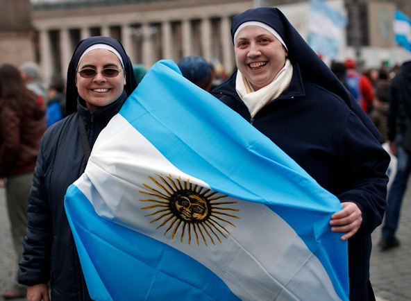 Nuns carrying an Argentine national flag smile after listening to Pope Francis lead his first Angelus from the window of his private apartment in St. Peter's Square at the Vatican March 17. (CNS photo/Paul Hanna, Reuters)