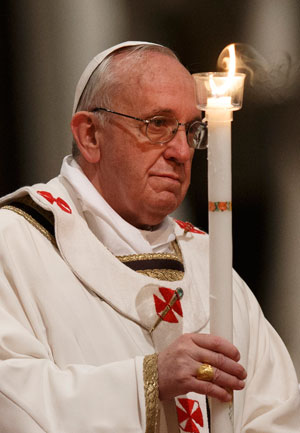 Pope Francis holds a candle as he celebrates the Easter Vigil in St. Peter's Basilica at the Vatican March 30. (CNS photo/Paul Haring)