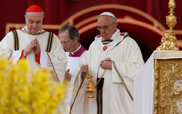 Pope Francis uses incense as the altar as he begins Easter Mass in St. Peter's Square at the Vatican March 31. Also pictured is Cardinal Angelo Comastri, archpriest of St. Peter's Basilica, left. (CNS photo/Paul Haring)