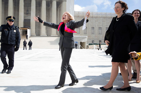 Edie Windsor, plaintiff in the lawsuit against the Defense of Marriage Act, gestures outside the Supreme Court in Washington March 27 after the justices heard oral arguments in the case. The court took up the constitutional challenge to the federal law a day after hearing arguments on the constitutionality of California's law banning same-sex marriage. (CNS photo/Joshua Roberts, Reuters)