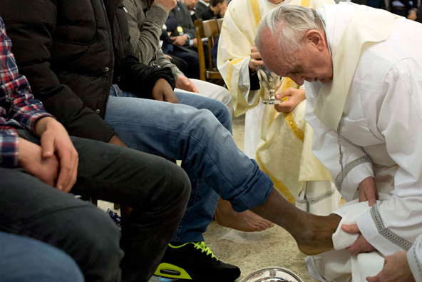 Pope Francis washes the foot of a prison inmate during the Holy Thursday Mass of the Lord's Supper at Rome's Casal del Marmo prison for minors March 28. Pope Francis washed the feet of 12 young people of different nationalities and faiths, including at l east two Muslims and two women, who are housed at the juvenile detention facility. (CNS photo/L'Osservatore Romano via Reuters)