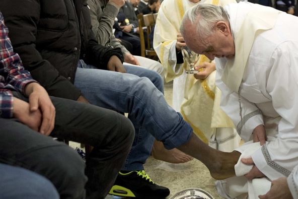 Pope Francis washes the foot of a prison inmate during the Holy Thursday Mass of the Lord's Supper at Rome's Casal del Marmo prison for minors March 28. Pope Francis washed the feet of 12 young people of different nationalities and faiths, including at l east two Muslims and two women, who are housed at the juvenile detention facility. (CNS photo/L'Osservatore Romano via Reuters)