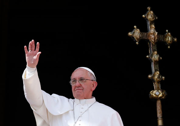 Pope Francis waves from the central balcony of St. Peter's Basilica as he delivers his Easter blessing "urbi et orbi" (to the city and the world) at the Vatican March 31. (CNS photo/Stephano Rellandini, Reuters)