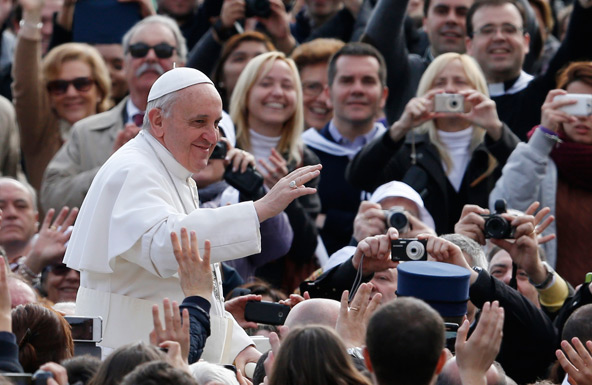 Pope Francis greets the crowd as he arrives to lead his general audience in St. Peter's Square at the Vatican April 3. (CNS photo/Paul Haring)