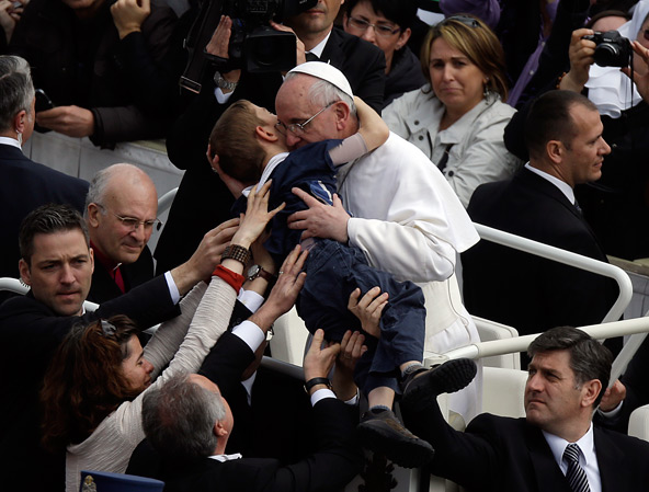 This photo by AP photographer Gregorio Borgia of Pope Francis embracing 8-year-old Dominic Gondreau, who has cerebral palsy, captured the attention of people around the world. The moment took place after the new pontiff celebrated his first Easter Mass i n St. Peter's Square at the Vatican March 31. (Gregorio Borgia, AP via CNS) 