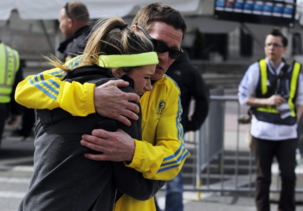 A woman is comforted by a man near a triage tent set up for the Boston Marathon after explosions went off at the 117th marathon April 15. Two bombs exploded in the crowded streets near the finish line of the marathon, killing at least three people, including an 8-year-old boy, and injuring more than 140. (CNS photo/Jessica Rinaldi, Reuters)