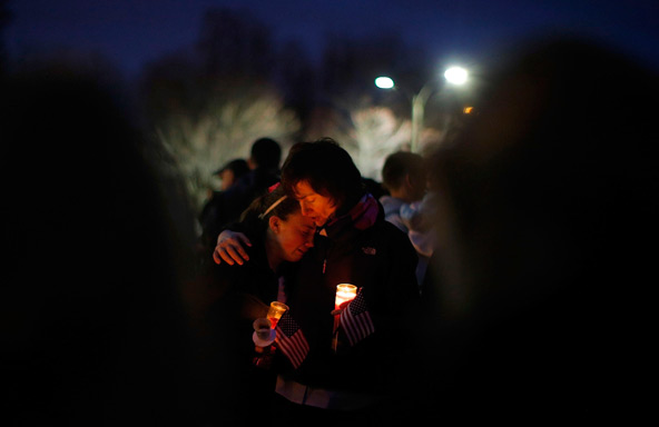 A young woman cries during a candlelight vigil April 16 in the Dorchester section of Boston, where Boston Marathon bombing victim Martin Richard lived. The 8-year-old boy, who attended St. Ann Parish Neponset in Dorchester with his family, was one of thr ee people killed when two bombs exploded in the crowded streets near the finish line of the marathon April 15. More than 170 people were injured, including the boy's mother and sister, who were seriously injured. (CNS photo/Brian Snyder, Reuters) 