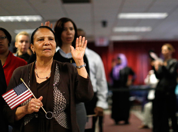 Immigrant Isabel Rivera from the Dominican Republic takes the oath of citizenship during a naturalization ceremony in New York, April 17. Immigration legislation introduced in the Senate April 17 includes many of the provisions long sought by advocates f or comprehensive reform, but months of work likely lie ahead to attempt to turn it into law. (CNS photo/Brendan McDermid, Reuters)