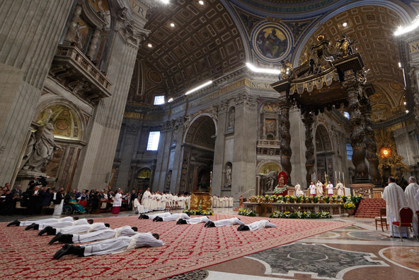 Ten priests lie prostrate during their ordination by Pope Francis in St. Peter's Basilica at the Vatican April 21. (CNS photo/Paul Haring)