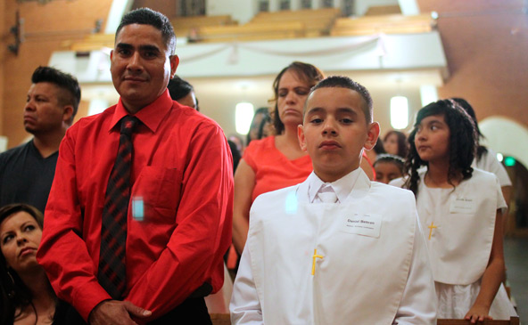 Daniel Beltran stands with others being baptized on Easter Vigil at Ss. Simon and Jude Cathedral. (J.D. Long-Garcia/CATHOLIC SUN)