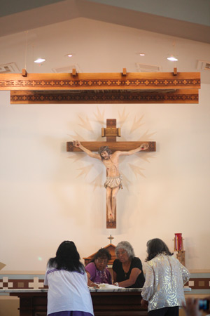 Community members prepare the altar during the April 13 dedication Mass. (J.D. Long-Garcia/CATHOLIC SUN)
