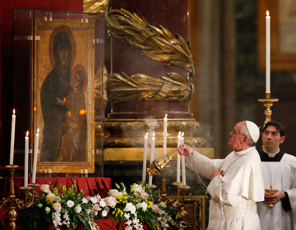 Pope Francis burns incense before the icon of Mary "Salus Populi Romani" (health of the Roman people) after praying the rosary during a service at the Basilica of St. Mary Major in Rome May 4. (CNS photo/Paul Haring)