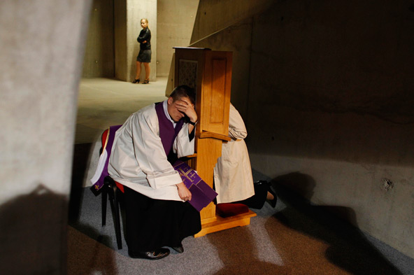 A priest listens to a confession during Mass in 2012 at the Temple of Divine Providence in Warsaw, Poland. Archbishop Rino Fisichella, president of the Pontifical Council for Promoting New Evangelization, said he repeatedly hears that "many people have b een going to confession and many have said that, while they hadn't gone in a long time, they felt touched by the words of Pope Francis." (CNS photo/Kacper Pempel , Reuters)