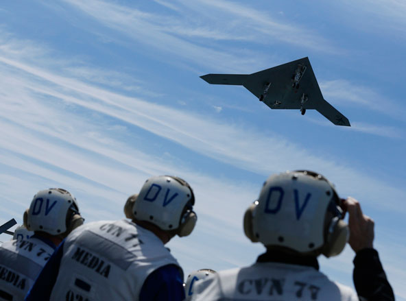 An X-47B pilot-less drone combat aircraft is launched for the first time off an aircraft carrier, the USS George H.W. Bush in the Atlantic Ocean off the coast of Virginia, May 14. The United States' use of unmanned aerial vehicles, or drones, to hunt dow n suspected terrorists poses serious moral questions stemming from just-war principles, said the chairman of the U.S. bishops' Committee on International Justice and Peace. (CNS photo/Jason Reed, Reuters)