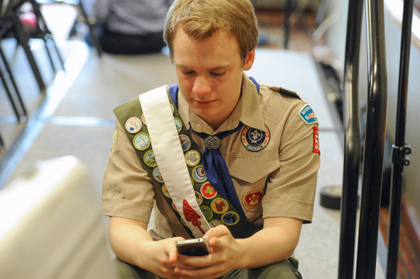 Pascal Tessier, 16, from Kensington, Md., who was facing expulsion from the Boy Scouts because he is gay, sends out a text message on his phone after a resolution to allow openly gay Scouts in the Boy Scouts of America was passed May 23. The vote came du ring the organization's annual meeting being held in the Dallas suburb of Grapevine, Texas. (CNS photo/Michael Prengler, Reuters) 