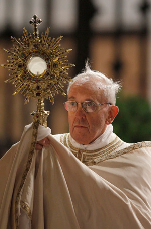 Pope Francis holds a monstrance during the observance of the feast of Corpus Christi at the Basilica of St. Mary Major in Rome May 30. (CNS photo/Paul Haring)