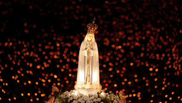 A statue of Our Lady of Fatima is carried during a candlelight vigil at the shrine in Fatima, Portugal, Oct. 12, 2007. Catholic celebrate her Feast Day May 13. (CNS photo/Nacho Doce, Reuters) 